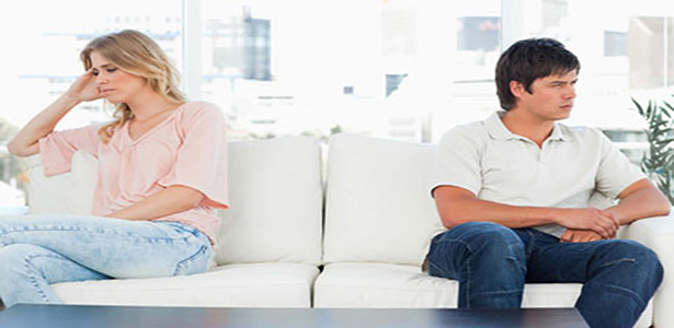 Man and woman sitting at opposite ends of couch because its not about you