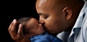 black dad kisses baby happy to see his kids